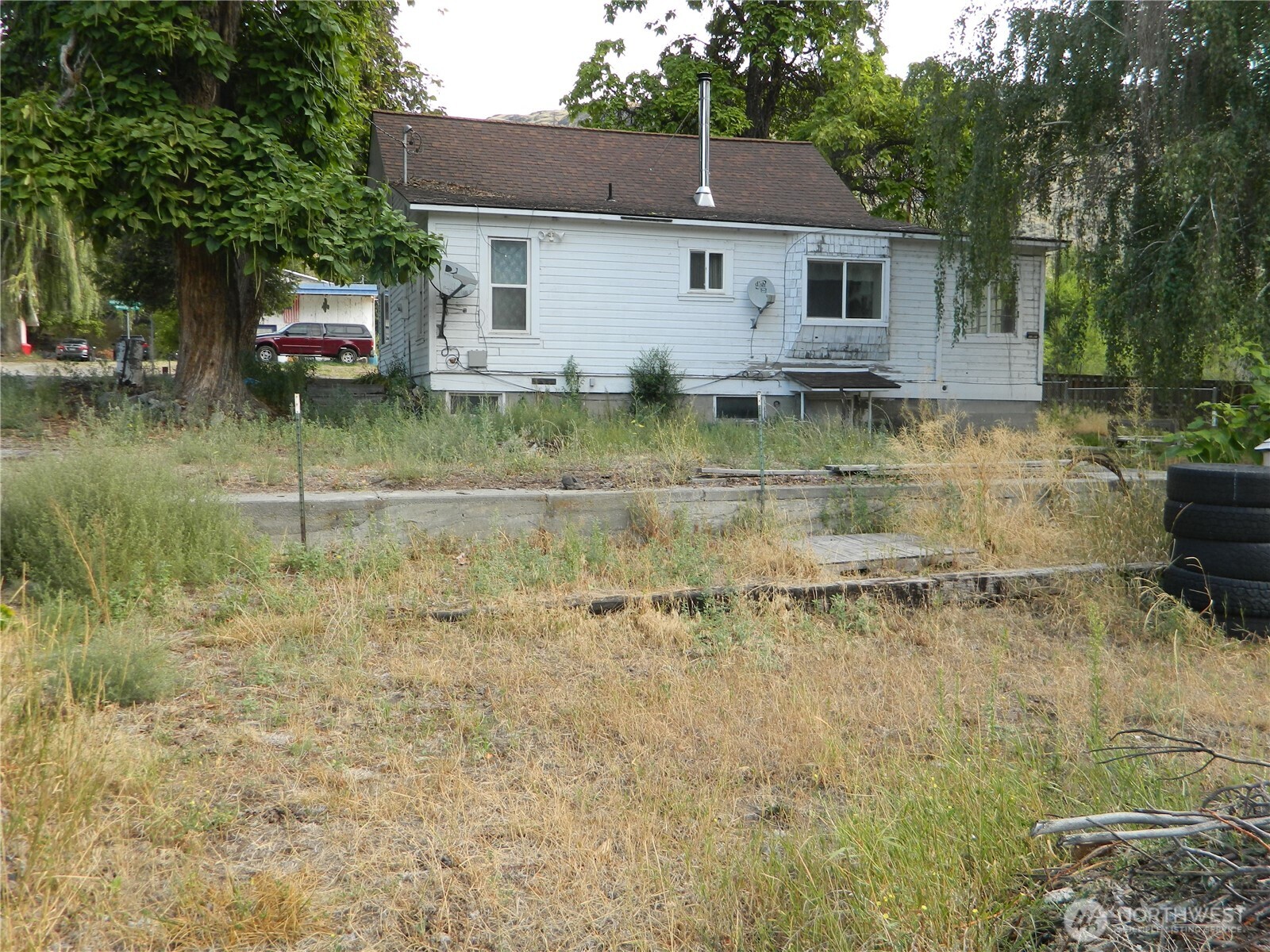 26 Palmer Avenue Loomis, WA 98827 - Photo 5 of 20 a view of a house with a yard and a water fountain