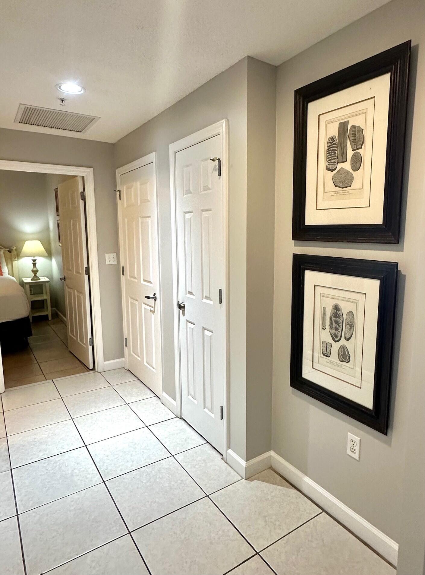 12011 Front Beach Road, Unit 103B Panama City Beach, FL 32407 - Photo 13 of 38 a view of a hallway with wooden shelves and cabinets