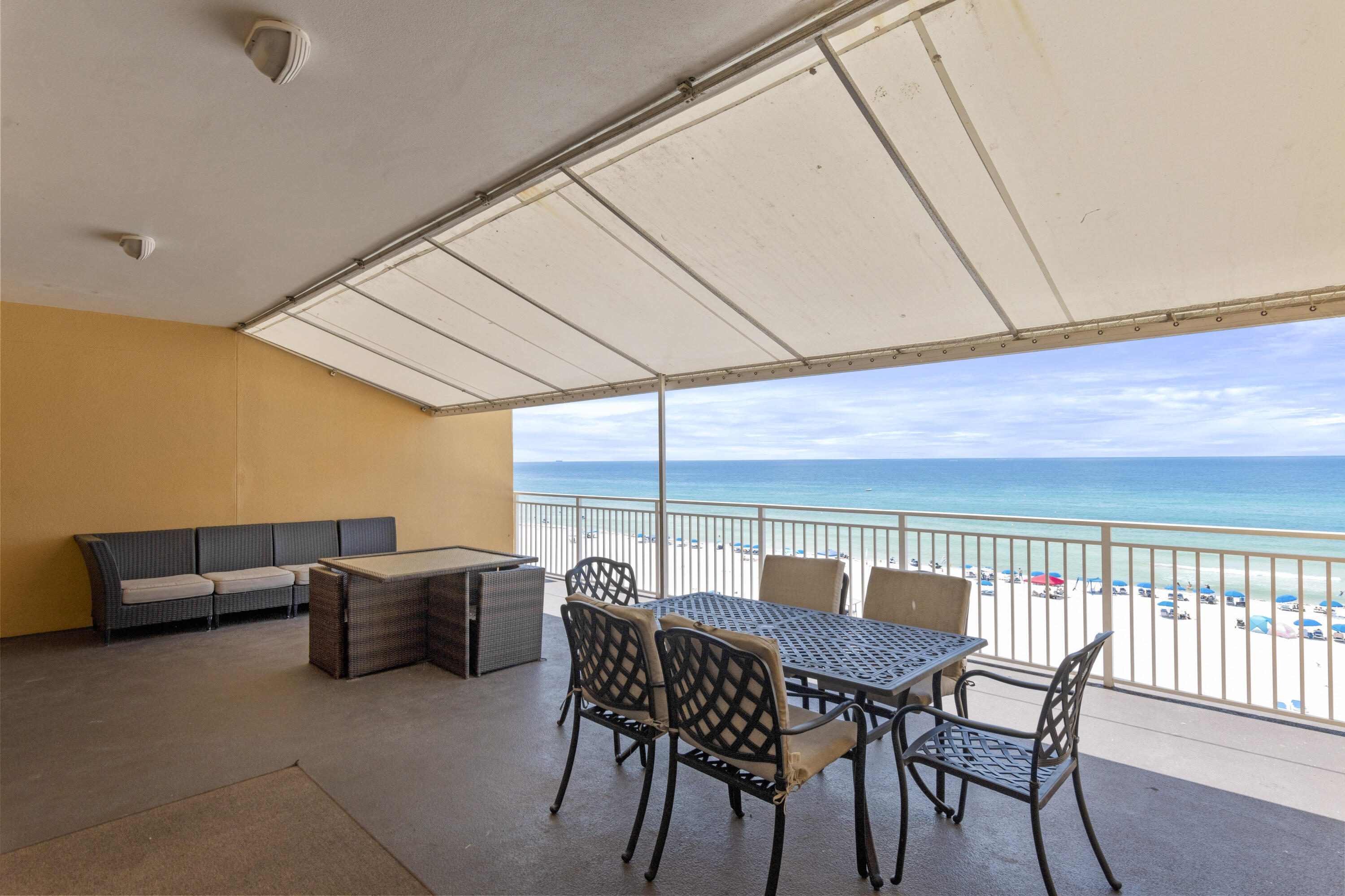 12011 Front Beach Road, Unit 103B Panama City Beach, FL 32407 - Photo 18 of 38 a view of a patio with a table and chairs