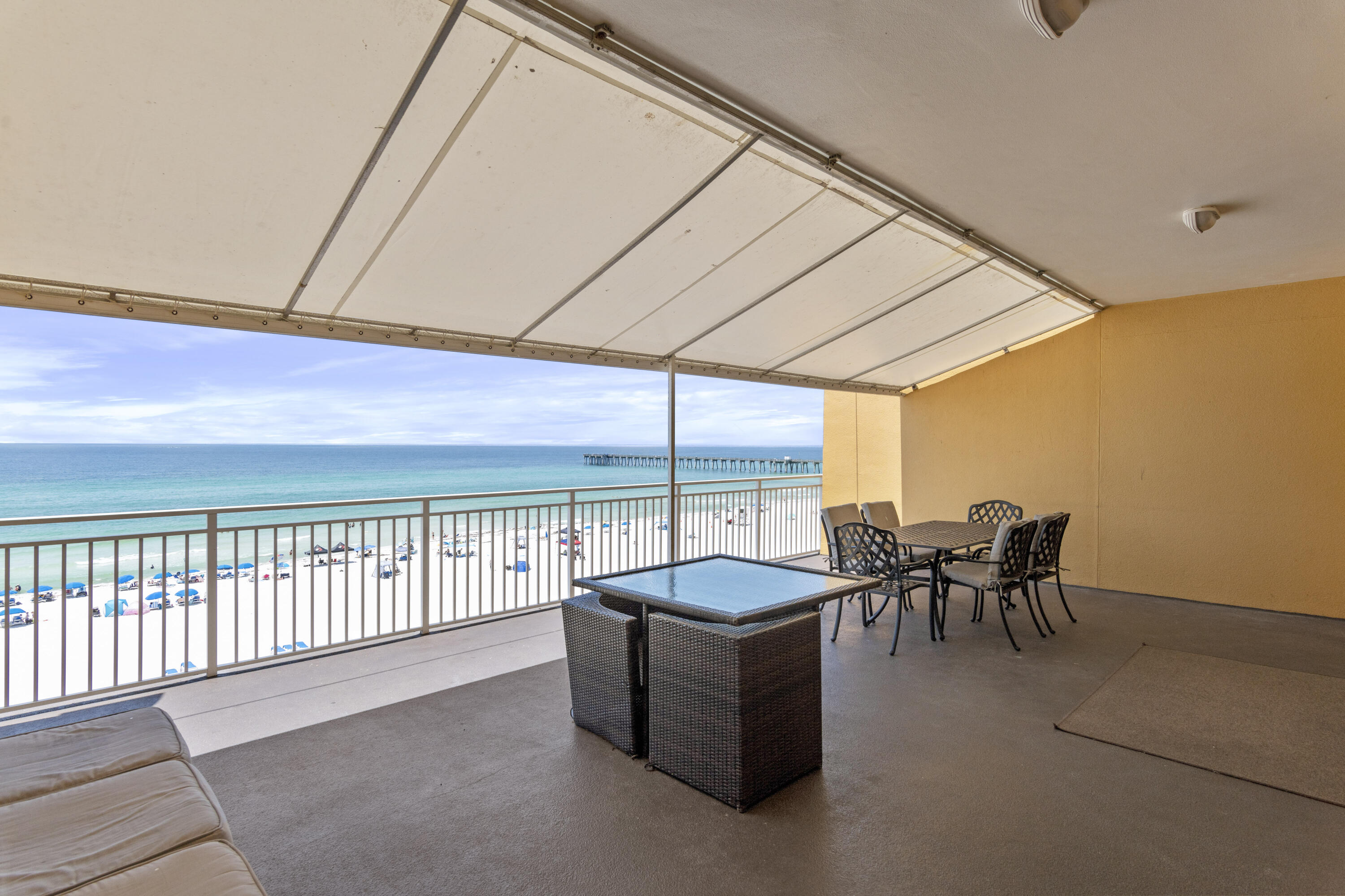 12011 Front Beach Road, Unit 103B Panama City Beach, FL 32407 - Photo 19 of 38 a dining room with furniture and a floor to ceiling window