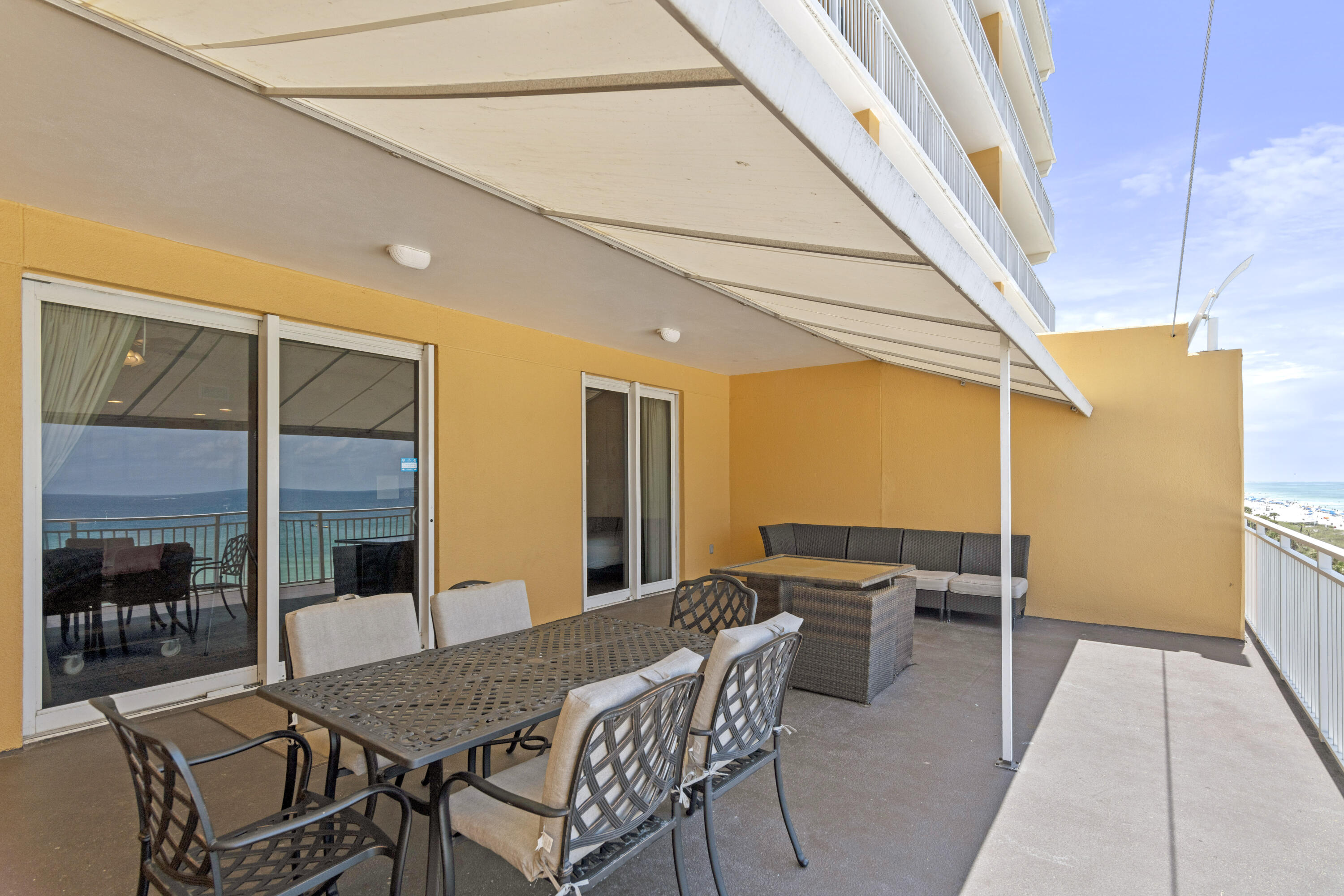 12011 Front Beach Road, Unit 103B Panama City Beach, FL 32407 - Photo 20 of 38 a patio with table and chairs