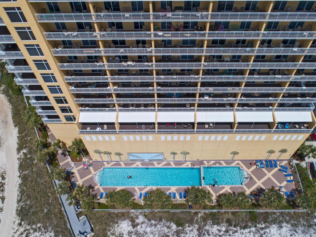 12011 Front Beach Road, Unit 103B Panama City Beach, FL 32407 - Photo 30 of 38 a view of a swimming pool with a lawn chairs