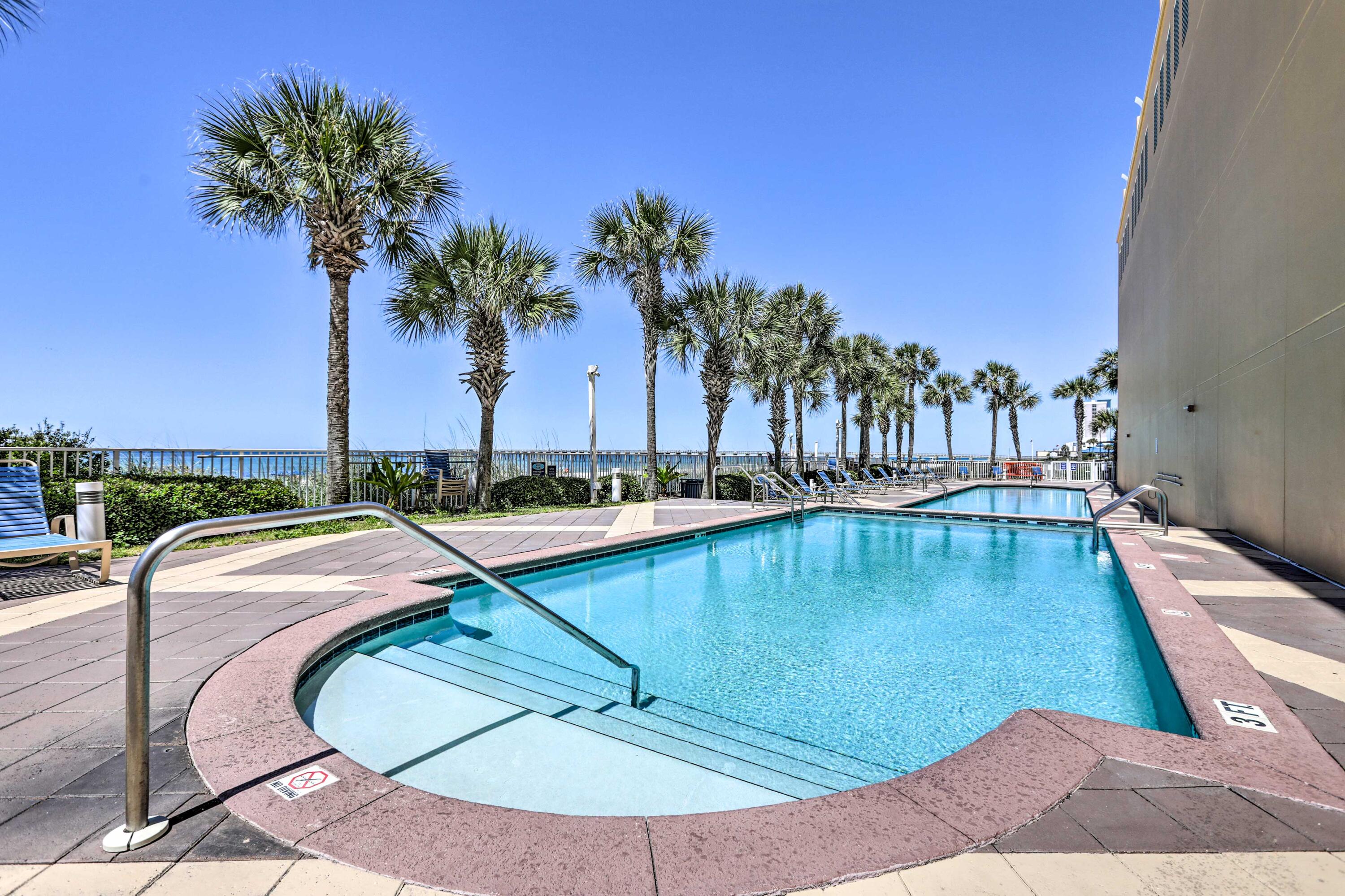 12011 Front Beach Road, Unit 103B Panama City Beach, FL 32407 - Photo 34 of 38 a view of a swimming pool with a lounge chair