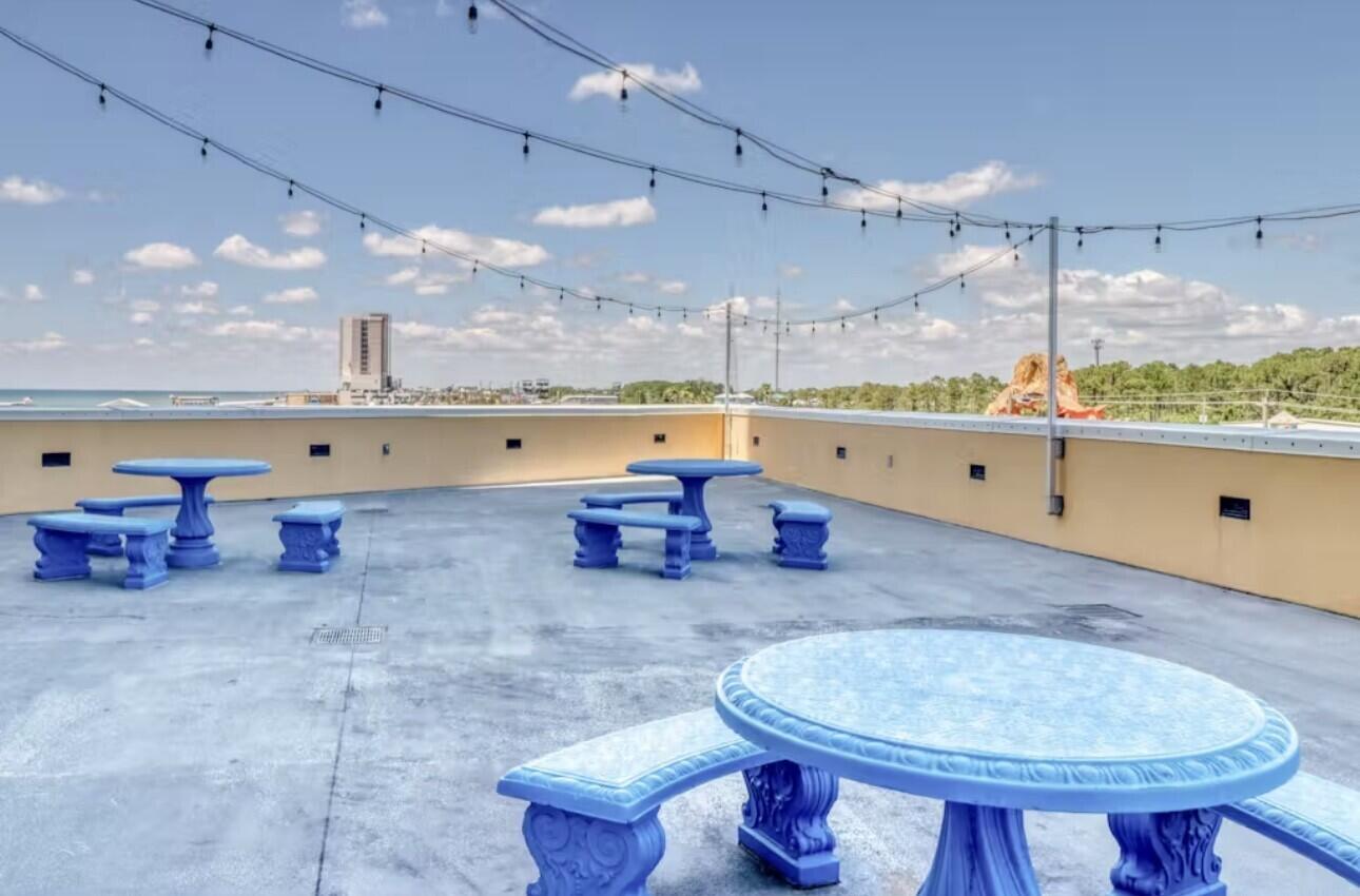 12011 Front Beach Road, Unit 103B Panama City Beach, FL 32407 - Photo 37 of 38 a room with lots of table chairs and a large window