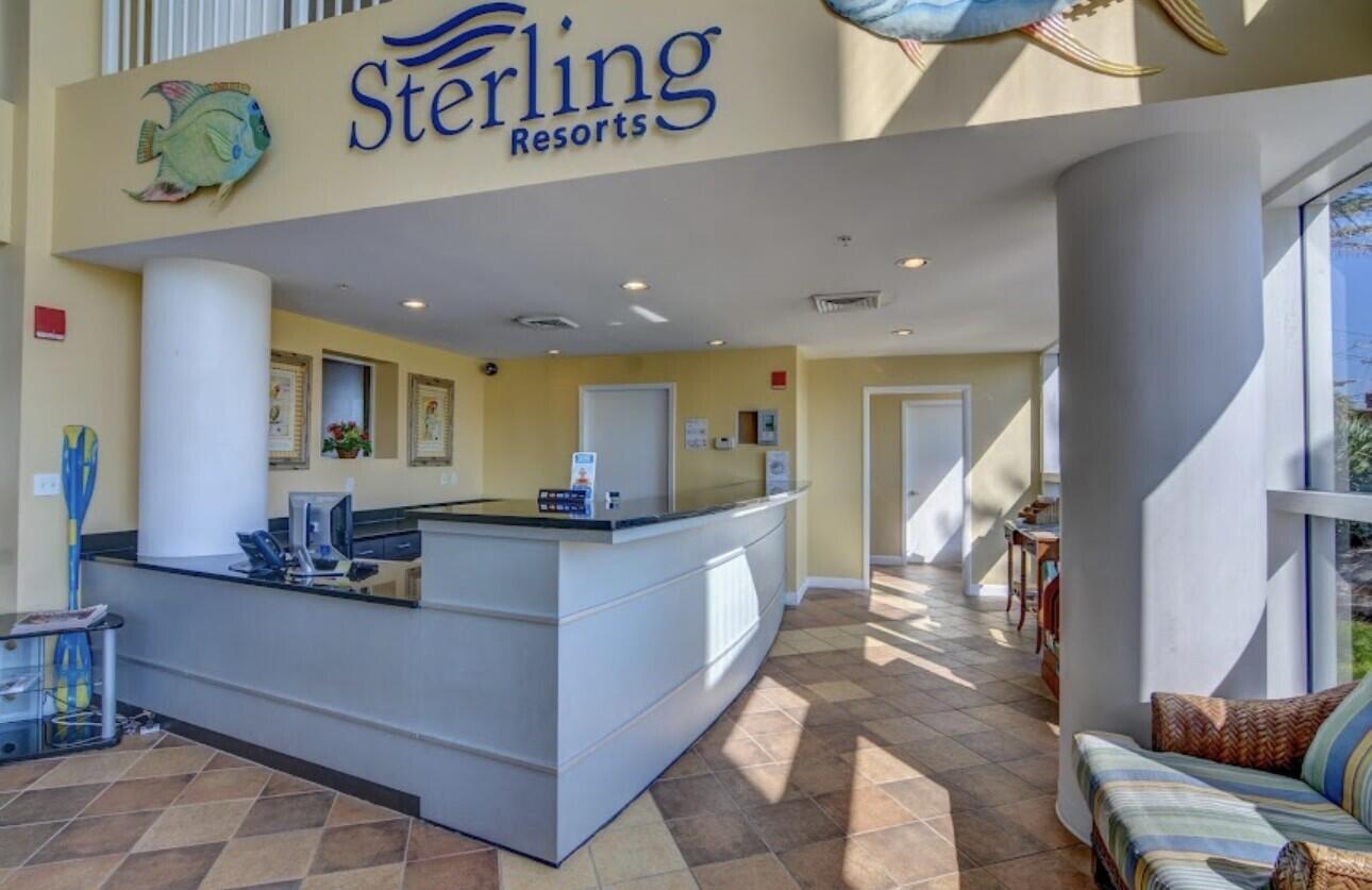 12011 Front Beach Road, Unit 103B Panama City Beach, FL 32407 - Photo 38 of 38 a kitchen with stainless steel appliances kitchen island granite countertop a table and chairs in it