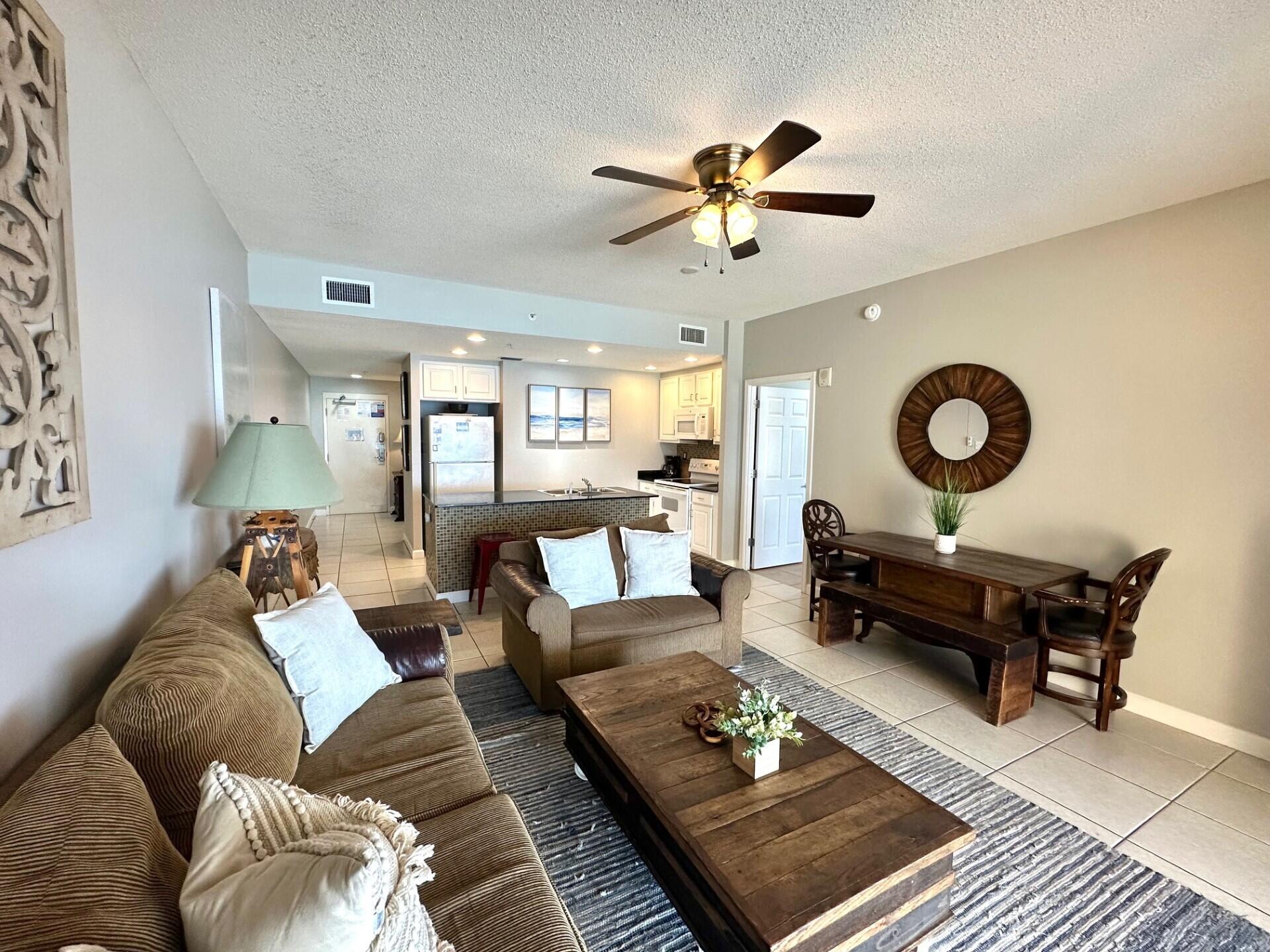 12011 Front Beach Road, Unit 103B Panama City Beach, FL 32407 - Photo 4 of 38 a living room with furniture and a rug