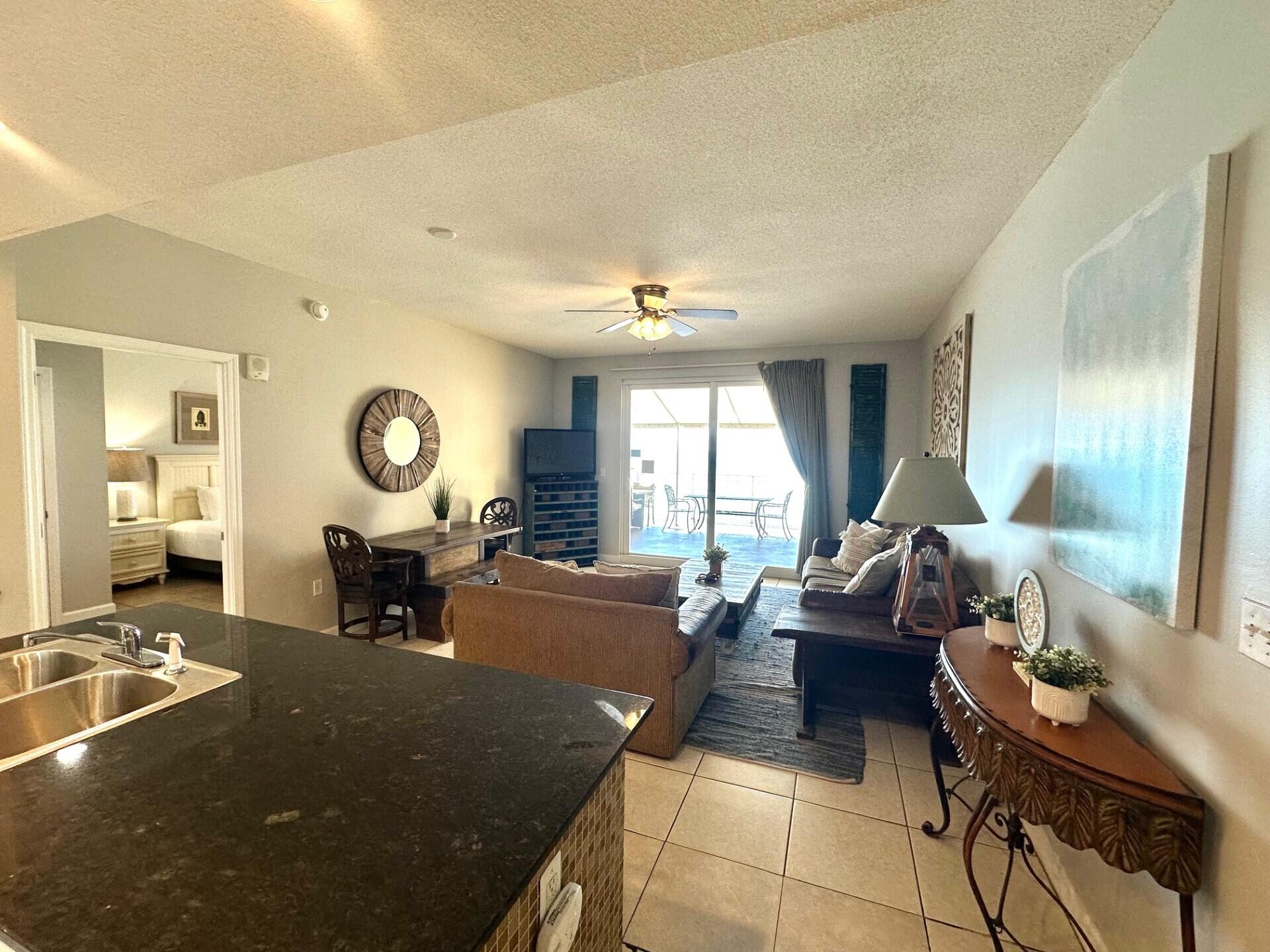 12011 Front Beach Road, Unit 103B Panama City Beach, FL 32407 - Photo 5 of 38 a living room with furniture and a large window