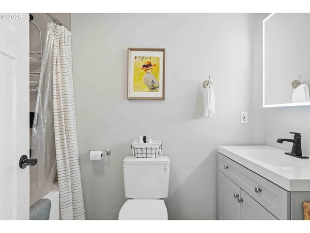 a bathroom with a sink mirror and toilet
