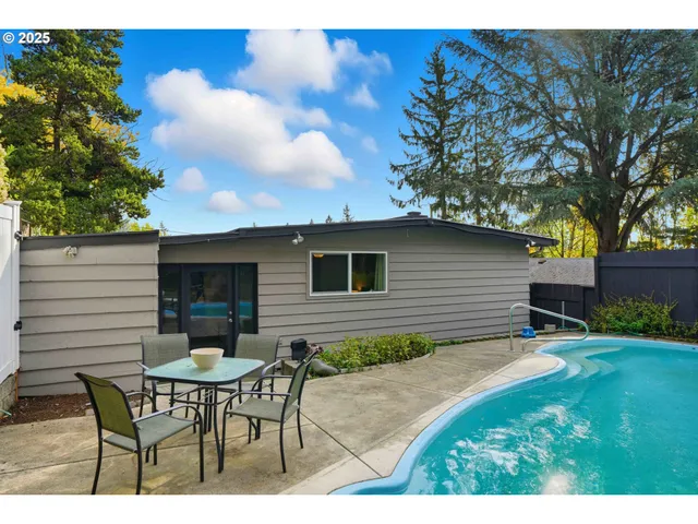 a backyard of a house with table and chairs