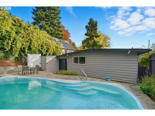 a backyard of a house with table and chairs