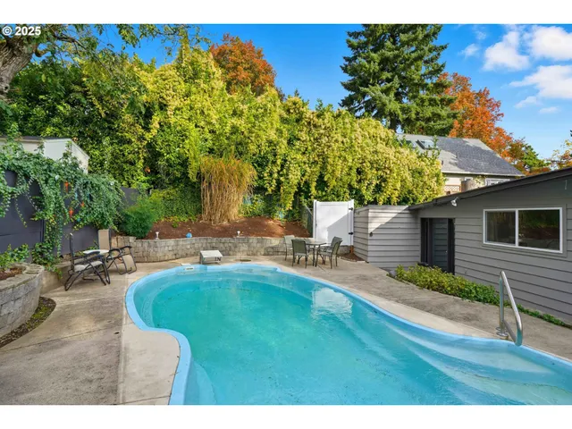 a swimming pool with outdoor seating and yard