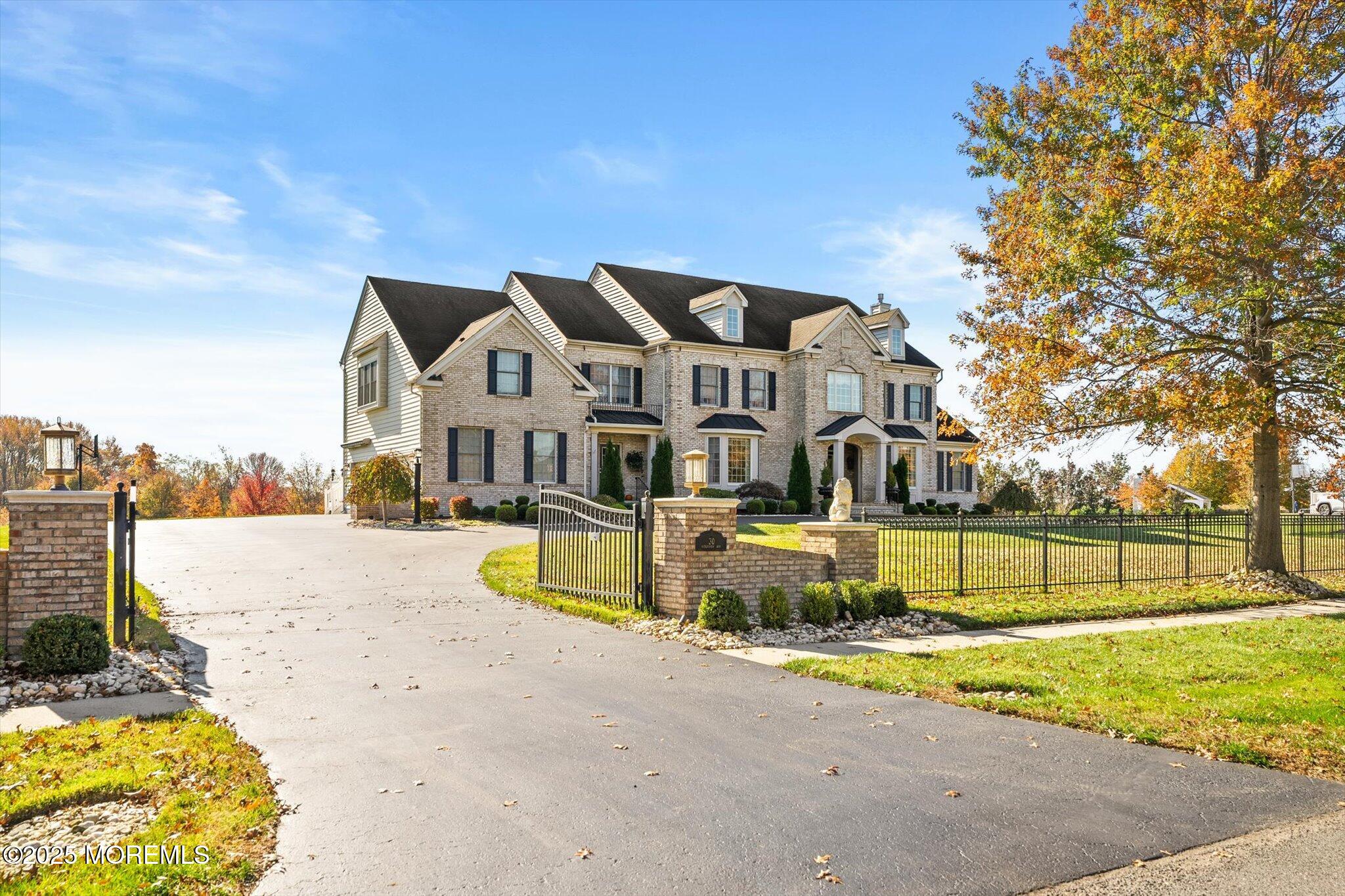 a view of a house with a big yard and large trees