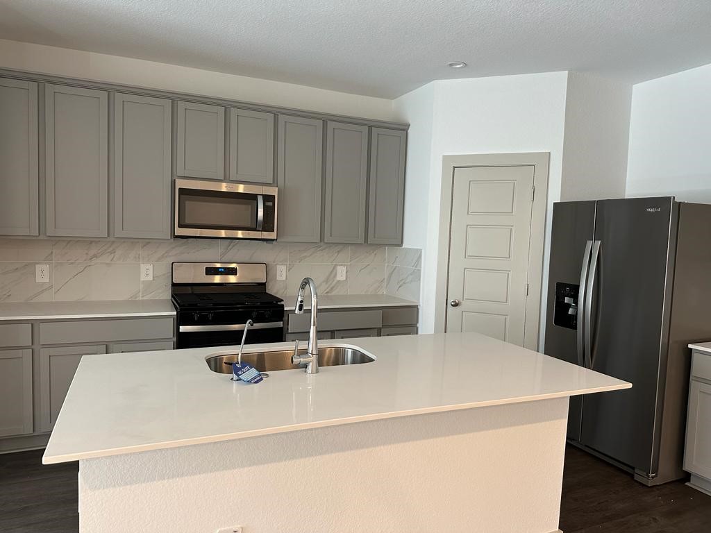 7815 Elm Birch Lane Rosharon, TX 77583 - Photo 8 of 19 a kitchen with a appliances a sink and cabinets