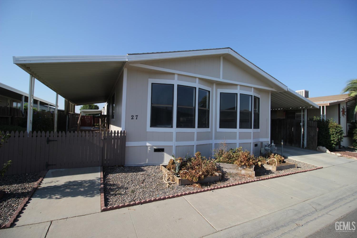Undisclosed Address Bakersfield, CA 93307 - Photo 12 of 18 a front view of a house with a yard