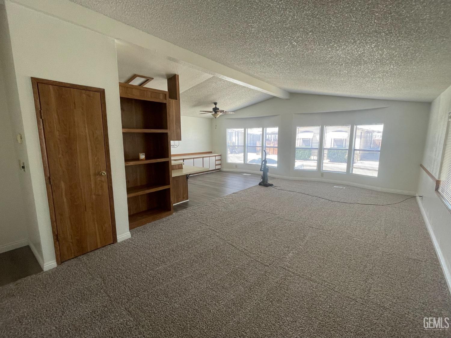 Undisclosed Address Bakersfield, CA 93307 - Photo 5 of 18 a view of empty room with cabinet and windows