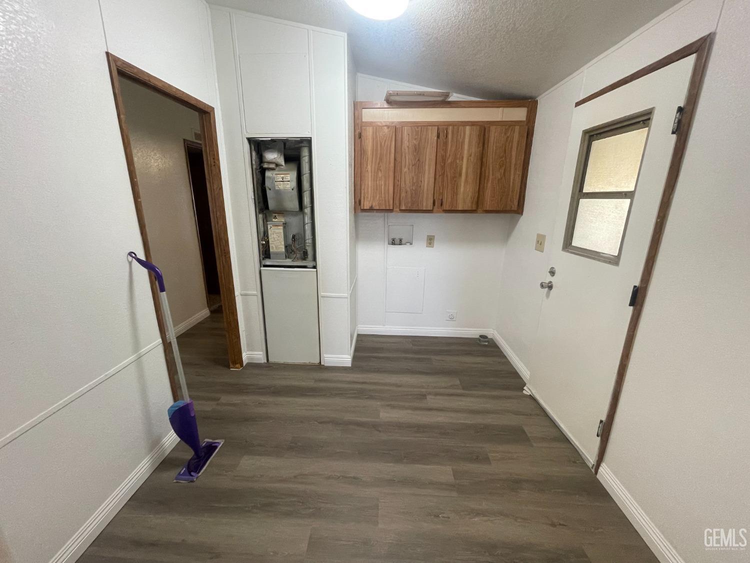 Undisclosed Address Bakersfield, CA 93307 - Photo 9 of 18 a view of a hallway with wooden floor and staircase