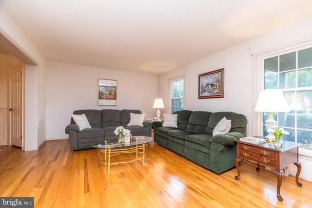 a large kitchen with granite countertop a large window cabinets and stainless steel appliances