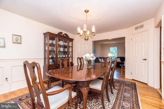 a view of a dining room with furniture and a chandelier
