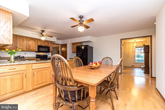 a spacious bedroom with a bed a dresser and next to a window
