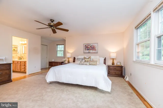 an aerial view of residential house with outdoor space and trees all around
