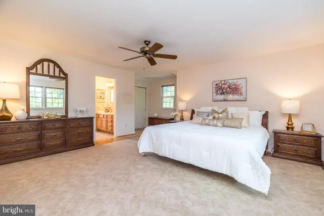 a view of a house with backyard and chairs