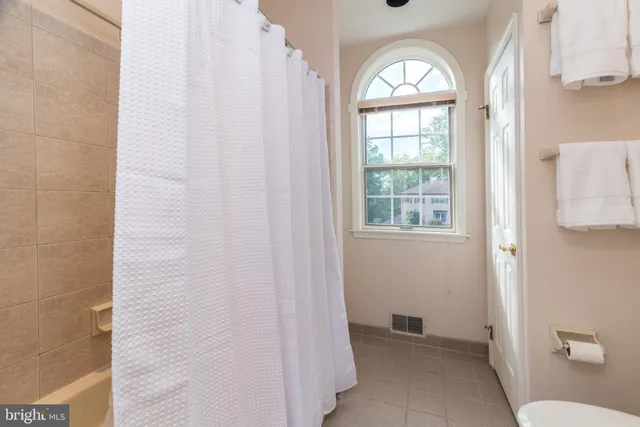 a view of a tall building next to a yard