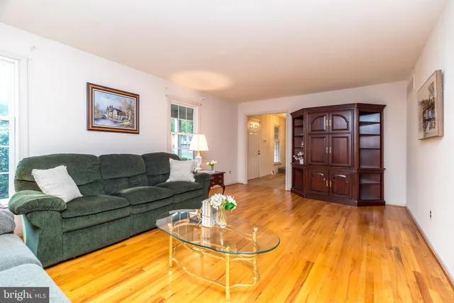 a kitchen with stainless steel appliances granite countertop a stove top oven a sink dishwasher a dining table and chairs with wooden floor