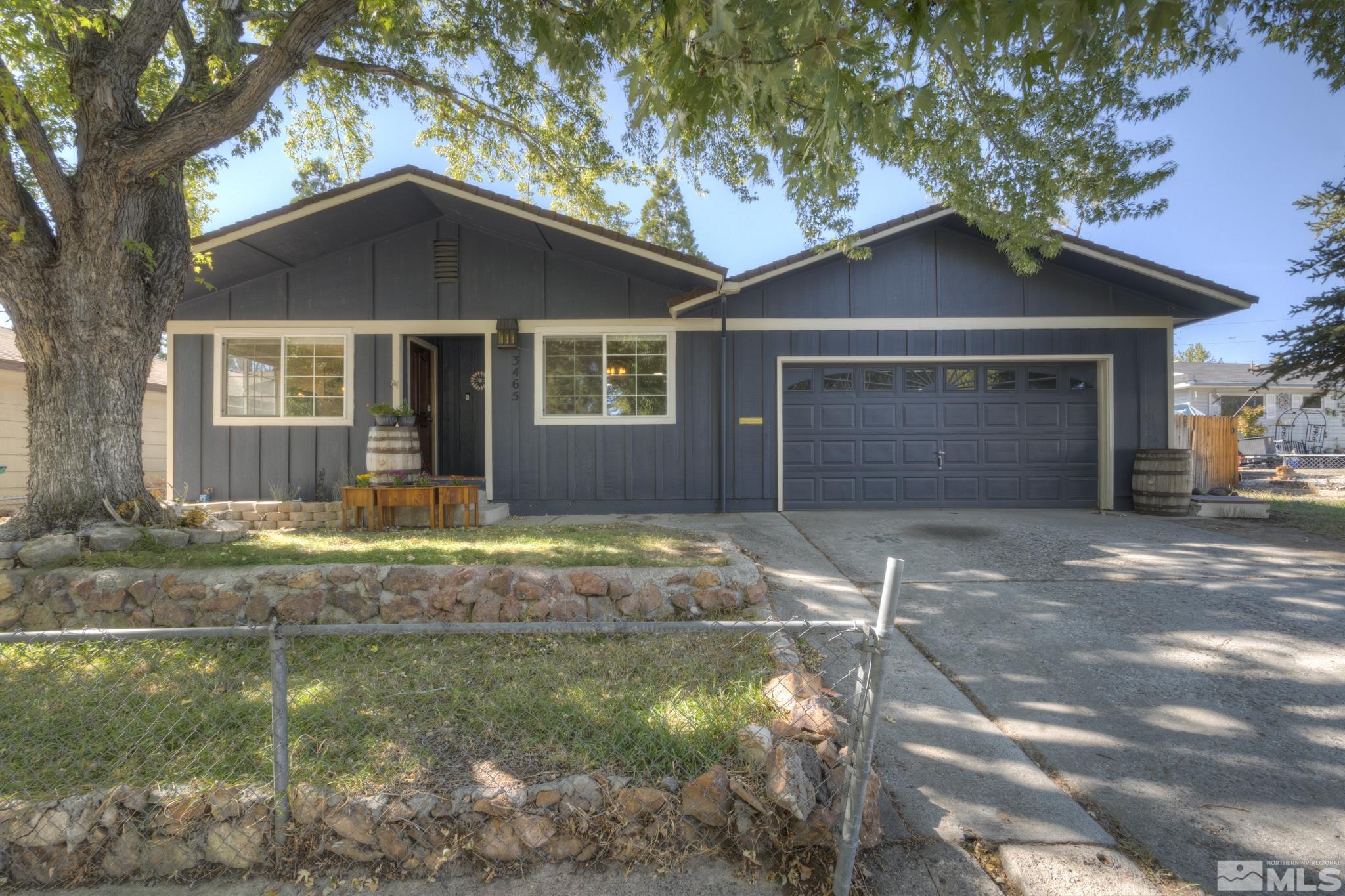 3465 Dawn Circle Sparks, NV 89431 - Photo 1 of 29 a front view of a house with a yard and garage