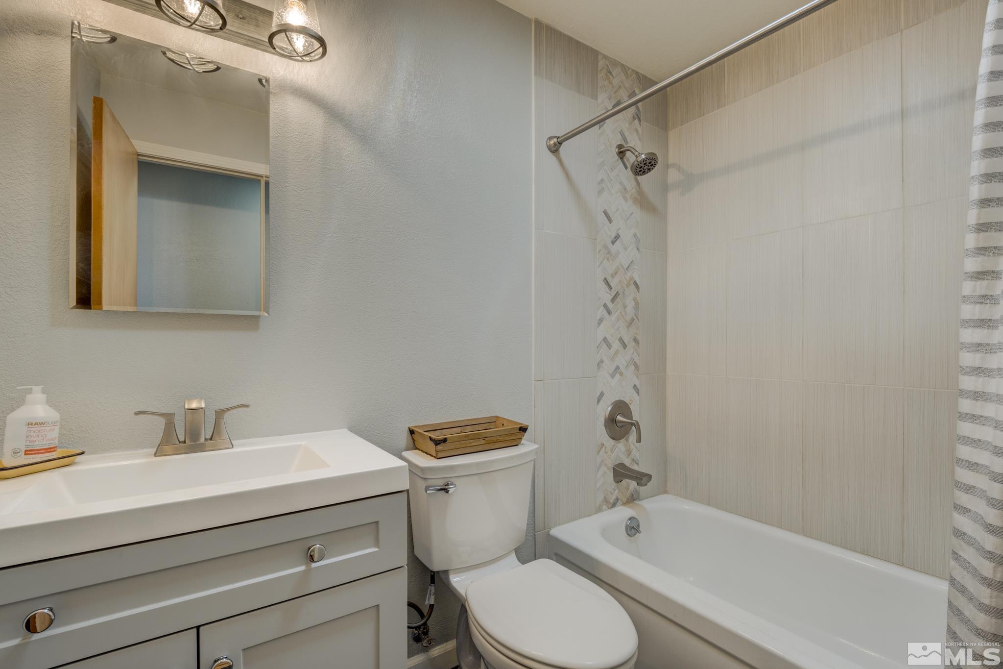 3465 Dawn Circle Sparks, NV 89431 - Photo 17 of 29 a bathroom with a sink a toilet and shower