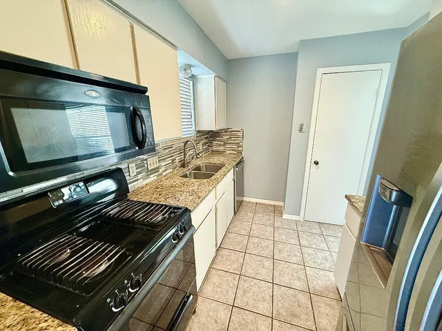 a kitchen with a stove and a microwave