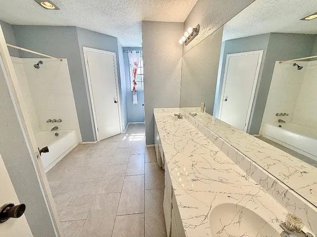 a bathroom with a sink and shower
