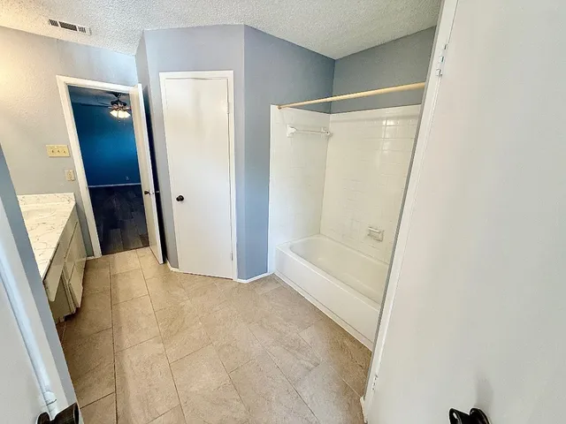 a view of bathroom with bathtub and shower