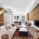 a living room with furniture fireplace and rug