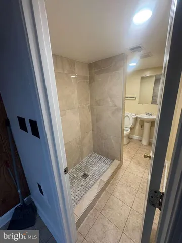 a bathroom with a sink and a glass door shower