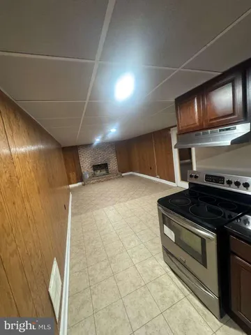 a view of a refrigerator in kitchen and a window