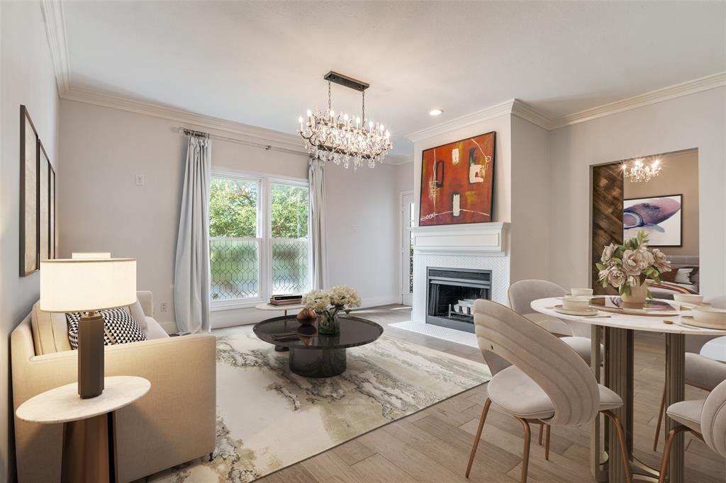 a living room with fireplace furniture and a large window