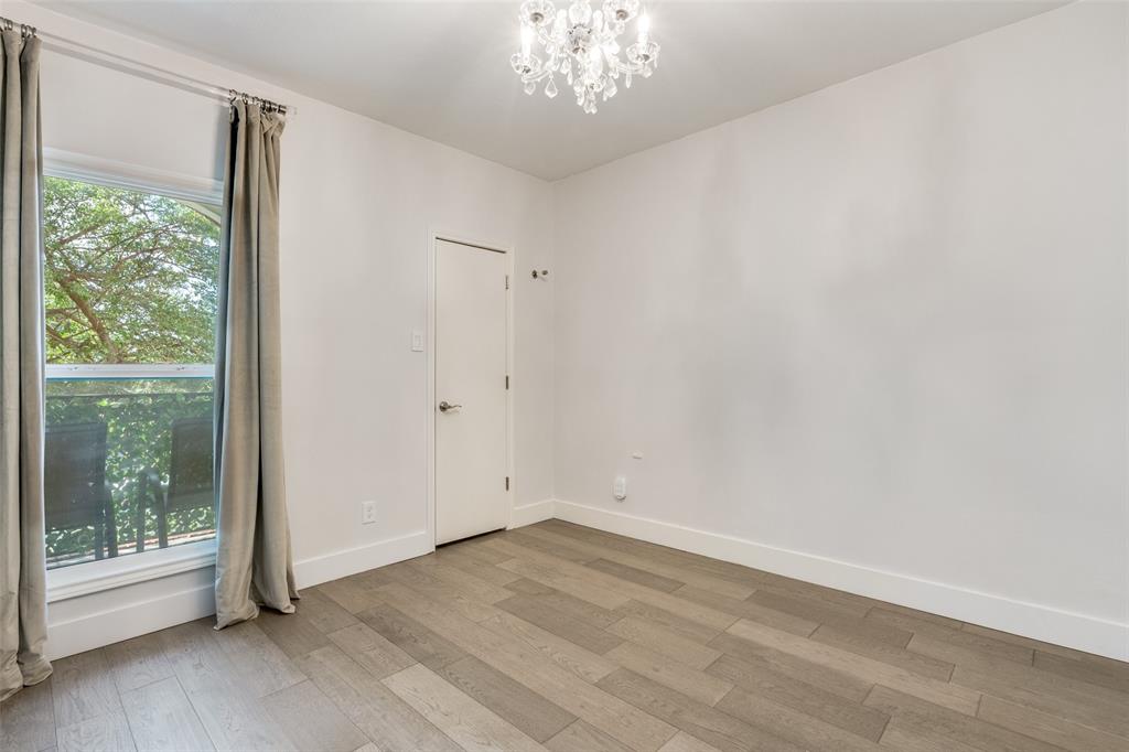 4034 Rawlins Street, Unit 104 Dallas, TX 75219 - Photo 11 of 19 a view of empty room with wooden floor and fan