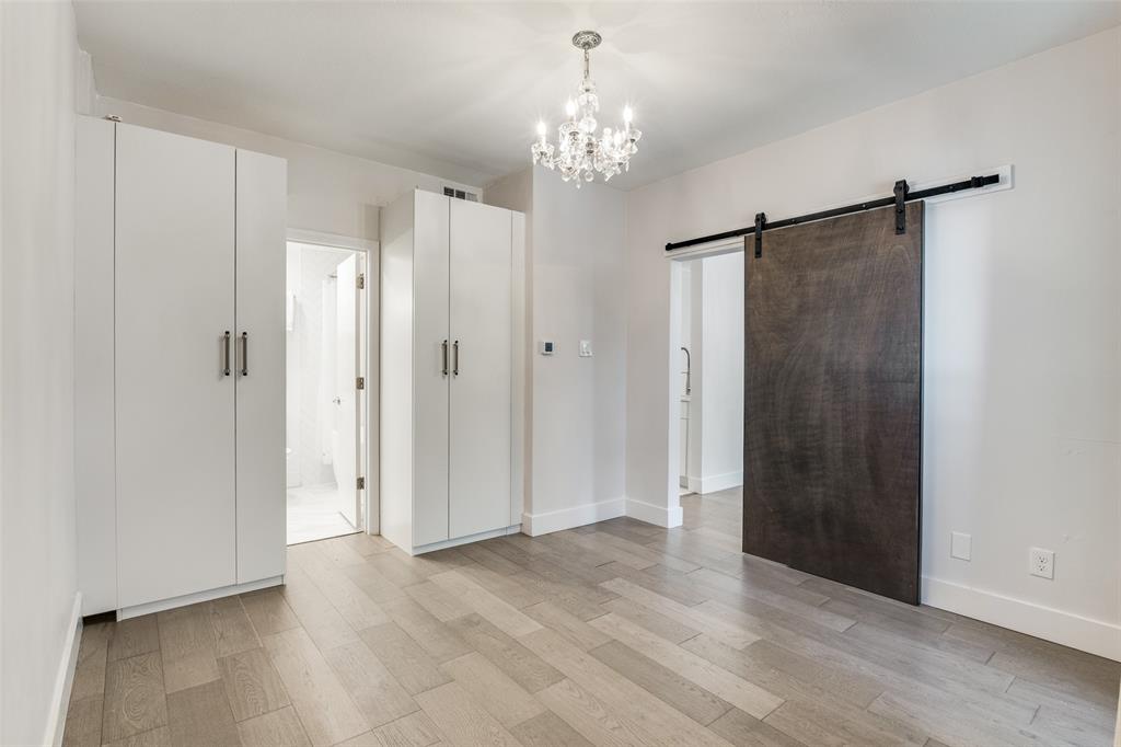 4034 Rawlins Street, Unit 104 Dallas, TX 75219 - Photo 12 of 19 a view of a chandelier in a room
