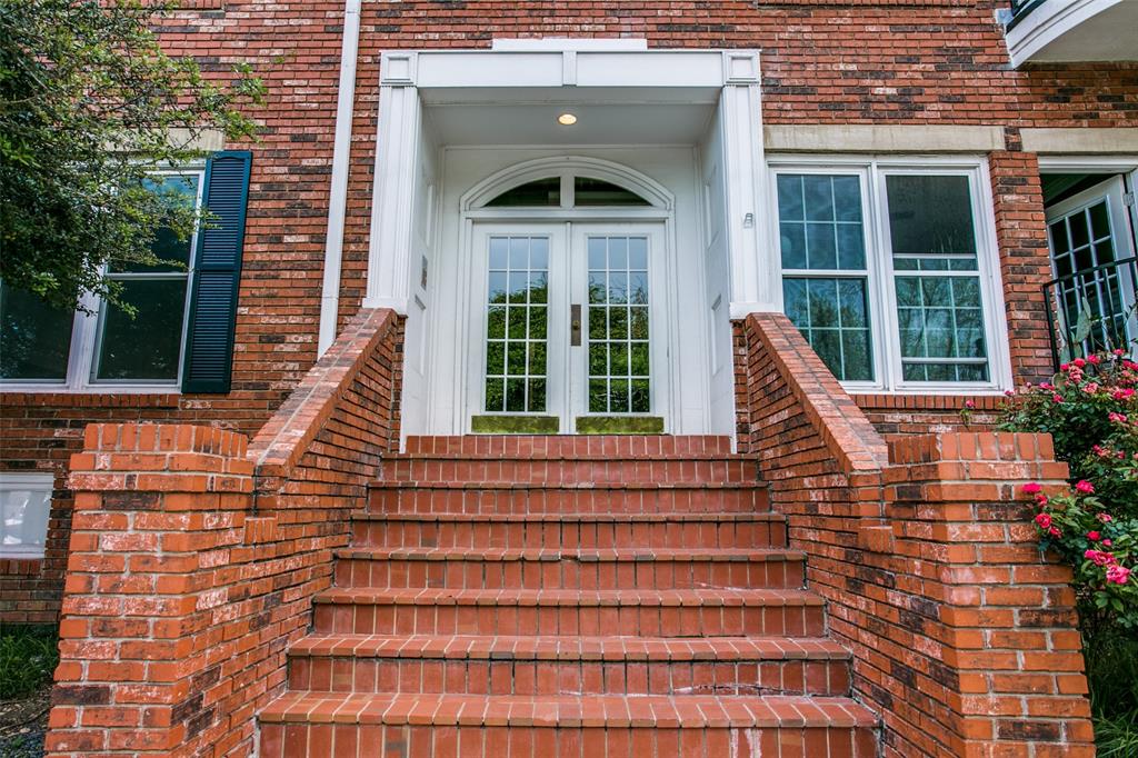 4034 Rawlins Street, Unit 104 Dallas, TX 75219 - Photo 17 of 19 a front view of a house with a yard