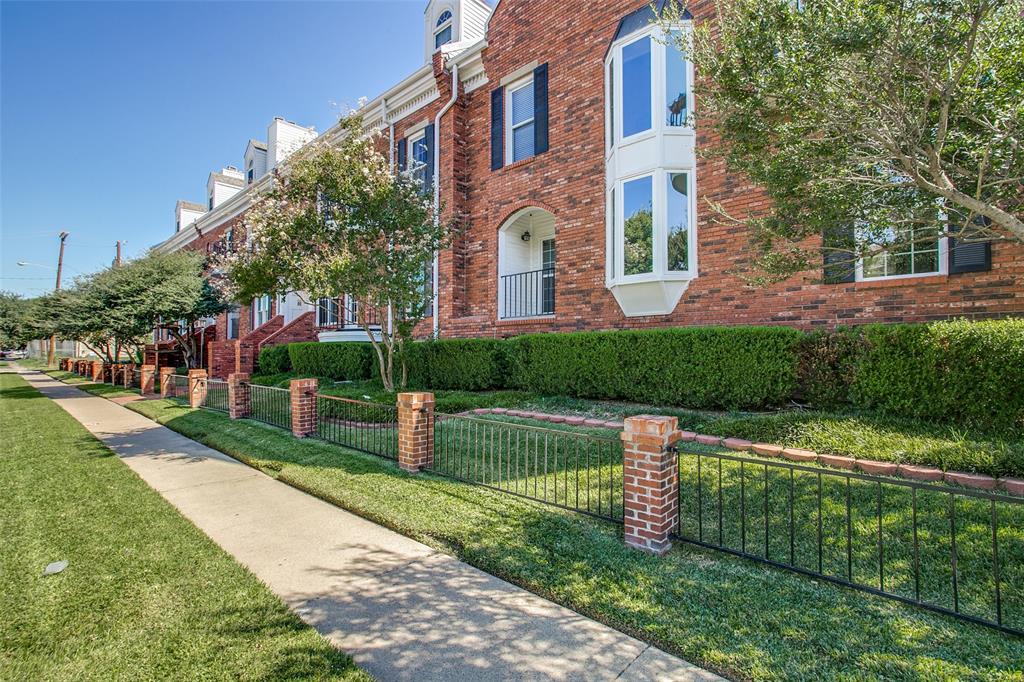 4034 Rawlins Street, Unit 104 Dallas, TX 75219 - Photo 18 of 19 a front view of a house with a yard and fountain