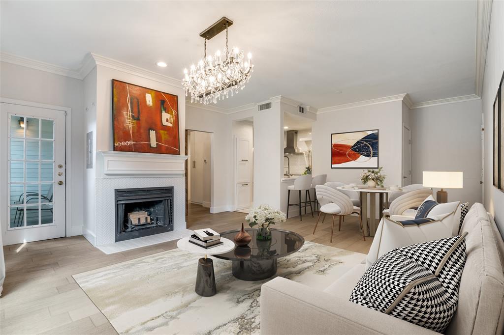4034 Rawlins Street, Unit 104 Dallas, TX 75219 - Photo 2 of 19 a living room with furniture a fireplace and a chandelier