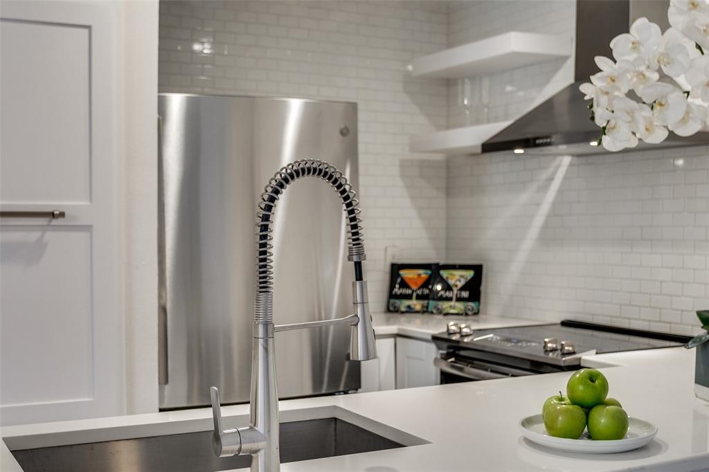 4034 Rawlins Street, Unit 104 Dallas, TX 75219 - Photo 10 of 19 a kitchen with a refrigerator and a stove