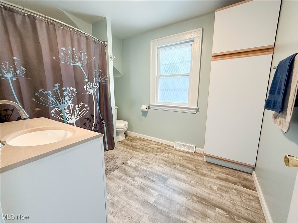 4672 Liberty Road South Euclid, OH 44121 - Photo 11 of 23 Full bath with wood finished floors, vanity, and a shower with shower curtain