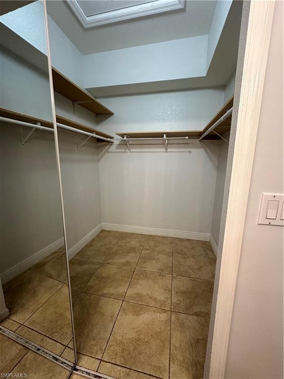 7350 Bristol Circle Naples, FL 34120 - Photo 12 of 14 Spacious closet featuring light tile patterned floors
