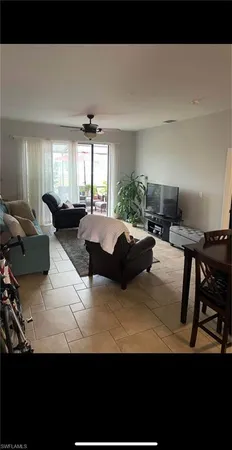 a living room with furniture a window and a table