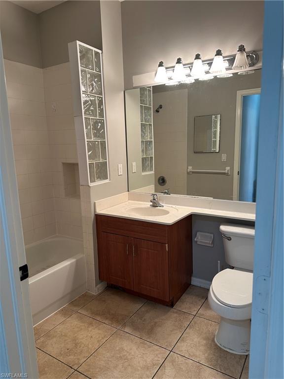 7350 Bristol Circle Naples, FL 34120 - Photo 9 of 14 Full bathroom with vanity, light tile patterned flooring, and shower / bathtub combination