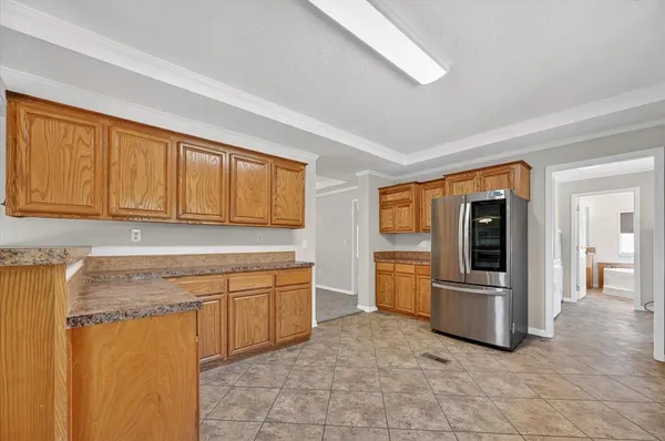 a view of a kitchen with stainless steel appliances granite countertop a refrigerator and a sink