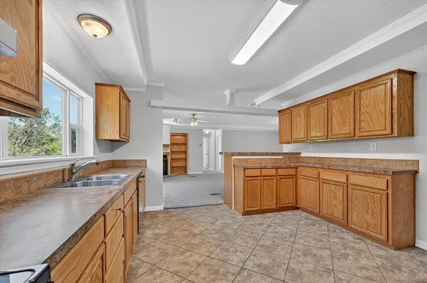 a kitchen with stainless steel appliances granite countertop a sink stove and cabinets