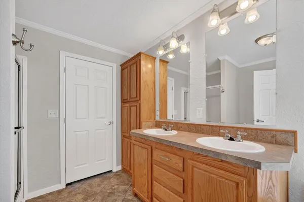 a bathroom with a sink double vanity and a mirror