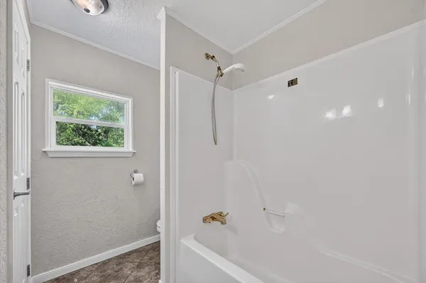 a bathroom with a bathtub and a shower